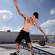 Some generic-looking white dude with tattoos grinding on some rail.